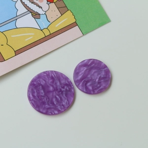 Macro view of purple marble pattern acrylic round charms for DIY jewelry and hair accessories