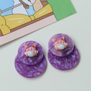 Close-up of purple acrylic round earrings with 3D cartoon girl character designs