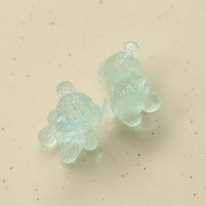 Macro view of light green jelly resin bears with 3D pleated texture for DIY crafts