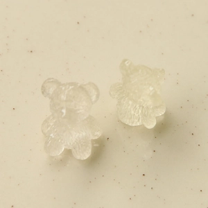 Macro detail of transparent resin bear charms with textured finish for DIY jewelry crafts
