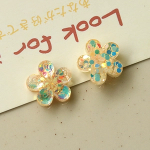 Macro shot of colorful resin flower charms with glitter for DIY earrings and phone cases