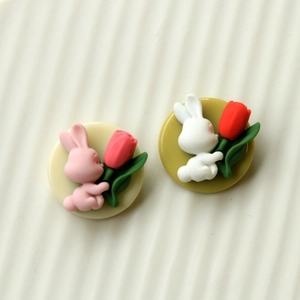 Detail of pink resin rabbit and tulip charms for DIY jewelry and hair accessories