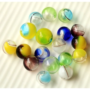 Macro shot of 16mm colorful striped gradient glass beads with spiral textures for DIY jewelry