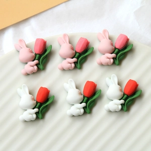 Close-up of resin rabbit and tulip DIY charms for hair accessories and phone cases