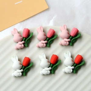 Detail of 3D resin cartoon bunny and tulip figurines for DIY phone case crafts