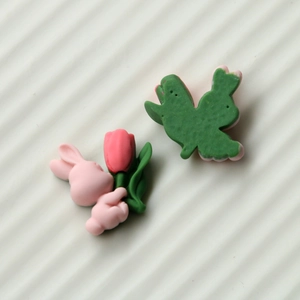 Detailed macro view of cute 3D resin rabbit and tulip DIY charms in pink and green