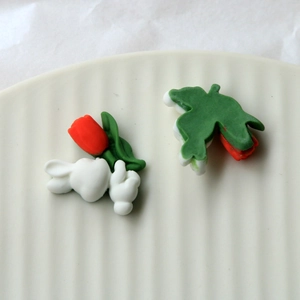 Detailed view of resin tulip bunny charms for DIY phone cases and hair accessories
