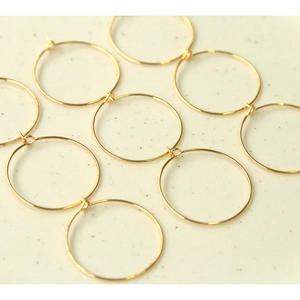 Macro shot of ten 30mm gold-plated geometric round hoops for DIY jewelry making