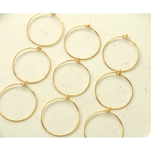 Detailed view of nine 30mm gold-plated round hoop earrings for DIY jewelry making