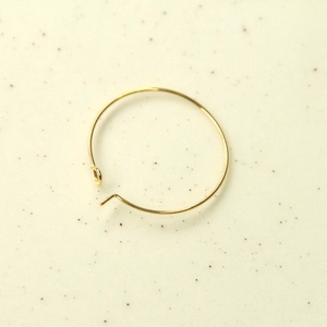 Close-up of 30mm gold-plated geometric round hoop earring finding with hook closure