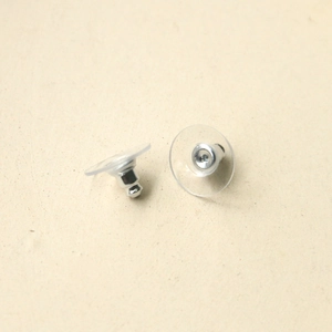 Macro view of clear disc earring backs with metal centers for secure stud placement