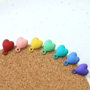 Detailed macro of colorful matte heart pendants for DIY jewelry making in rainbow colors