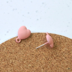 Macro view of matte pink heart stud earrings with integrated small hanging loop