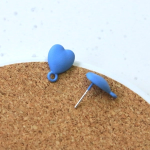 Macro detail of matte blue heart earrings showing smooth paint finish and metal posts