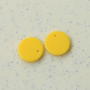 Makro-Detail von 16mm hellgelben Acryl-Rundanhängern mit Einzelloch für DIY-Schmuckbau