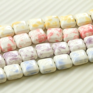 Dreamy cow print ceramic beads in yellow, pink, purple, and blue for DIY jewelry making