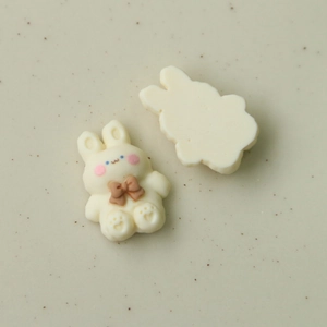 Close-up of cute rabbit resin accessories for DIY jewelry with detailed front and back