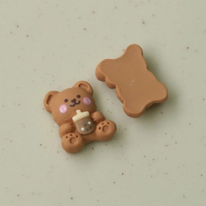 Detailed front and back view of brown resin bear charm holding bubble tea for DIY crafts