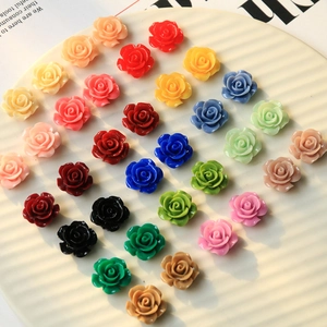Colorful resin flower charms for DIY jewelry and crafts on white display tray
