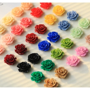 Detailed view of colorful resin rose flower charms for DIY crafts and jewelry making