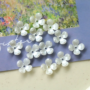Pearlescent white four-leaf flower charms for DIY jewelry making and handmade crafts