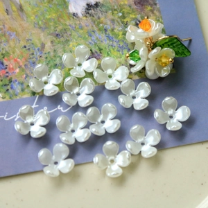 Macro detail of white pearl orchid flower beads with center holes for DIY jewelry making