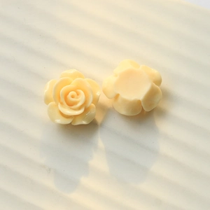 Detail of cream yellow resin rose charms showing both front petals and flat back base