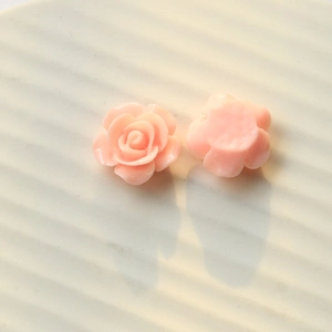 Macro view of pink resin rose flower charms with flat back and layered petal details