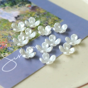 Macro detail of pearlescent white flower beads for DIY jewelry and hair accessories