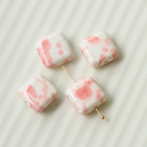 Macro view of square pink marble pattern ceramic beads for DIY jewelry making