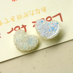 Vista dettagliata di ciondoli a cuore in resina glitterata per creazione gioielli DIY