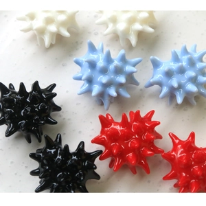 Detailed macro view of colorful 3D resin heart-shaped spiky urchin balls for DIY crafts