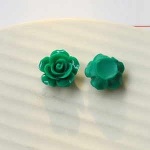 Detailed macro view of green resin rose charms for DIY jewelry and ear stud accessories