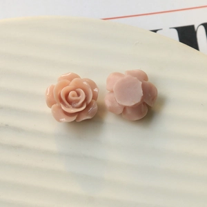 Detail showing front floral relief and flat back of pink resin rose DIY accessories