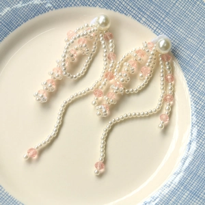 Detailed view of French vintage pearl tassel pendant with pink faceted beads for DIY jewelry