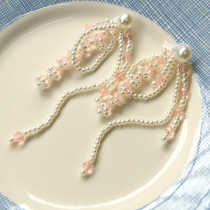 Detailed view of French vintage pearl tassel earrings with pink crystal beads