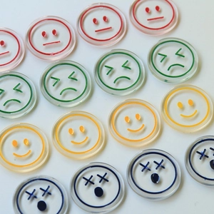 Colorful transparent acrylic smiley face charms in red green yellow and blue patterns