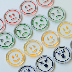 Macro view of colorful resin smile face charms in a neat grid for DIY accessories