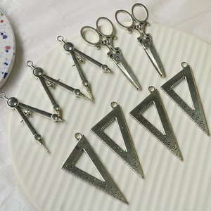 Vintage silver alloy DIY charms featuring creative compass, scissors, and ruler tool shapes