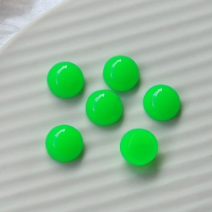 Macro detail of six neon green resin heart cabochons for DIY jewelry and phone cases