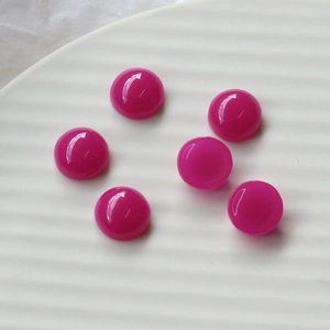 Macro view of 12mm fluorescent rose pink resin heart charms for DIY jewelry and nail art