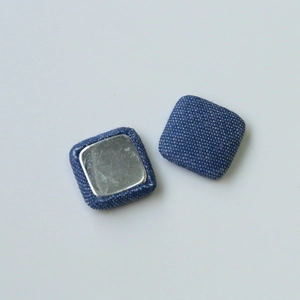Detail of denim fabric square button accessories with silver metal backing for DIY