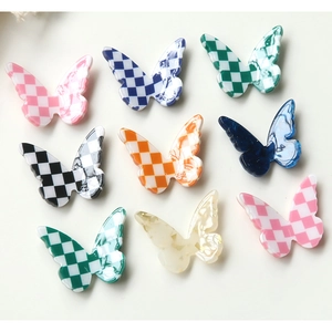 Macro view of checkered resin butterfly accessories for DIY jewelry and phone cases