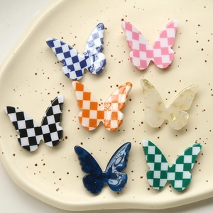 DIY butterfly resin charms in checkerboard and gold foil patterns for hair clips