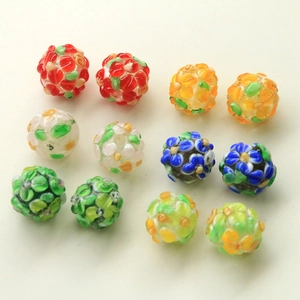 Macro detail of handmade colorful floral glass beads with intricate stereoscopic patterns