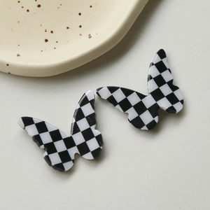 Handcrafted checkerboard butterfly resin charms for DIY jewelry and hair accessories