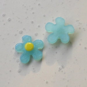 Macro shot of translucent light blue resin flower petals for DIY jewelry accessories