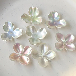 Close-up of iridescent AB colorful clover flower beads for DIY jewelry making and crafts