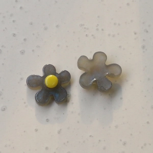 Detailed macro view of translucent jelly flower resin charms for DIY jewelry and crafts