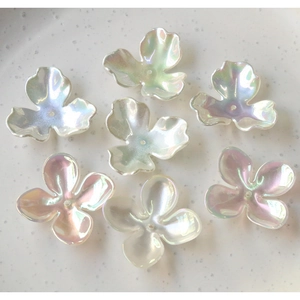 Macro view of iridescent clover flower beads with rainbow pearl finish for DIY jewelry